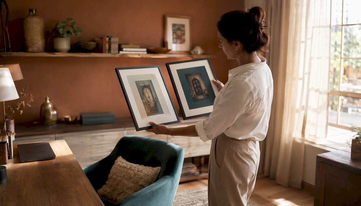 Homeowner comparing framed wall art contrast