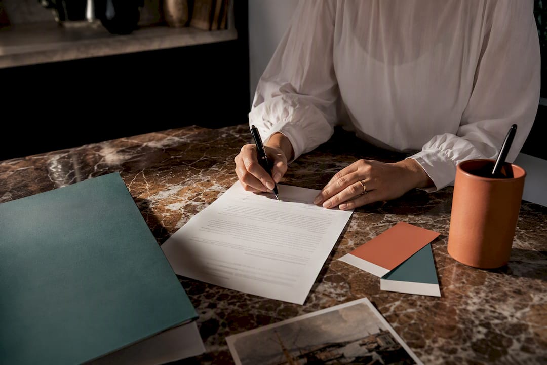 Client signing an art commission agreement