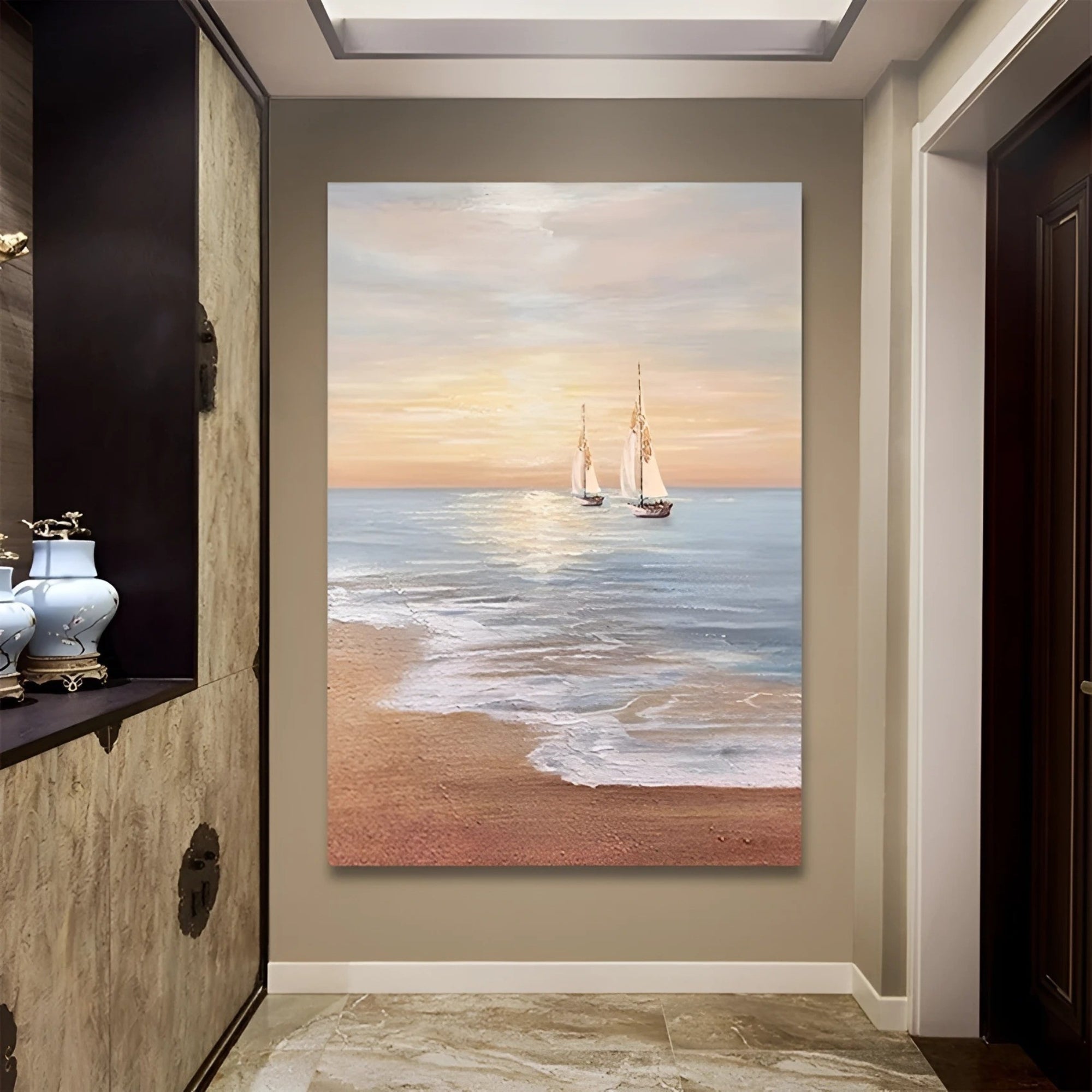 Sunset over the sea with two sailboats on the horizon, beautifully framed and displayed above a rustic wooden console with potted greenery.
