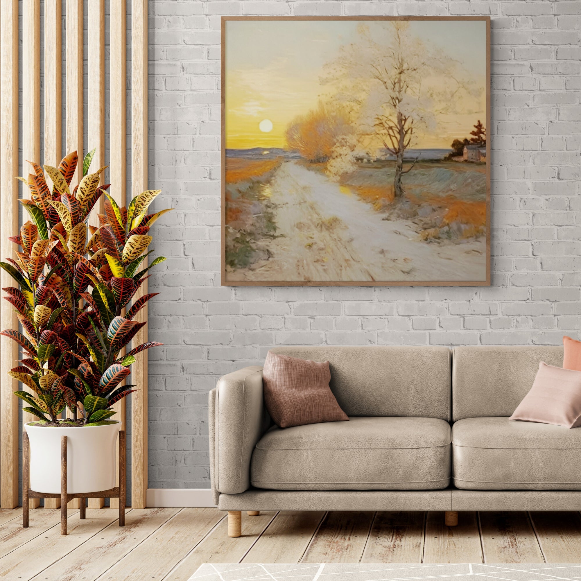 Hand-painted countryside sunset canvas, handmade, above beige sofa and decorative indoor plant.