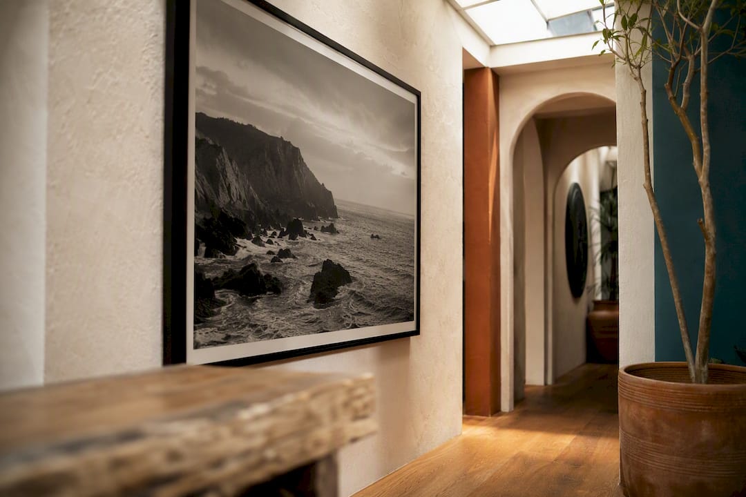 Large monochrome seascape photograph on wall