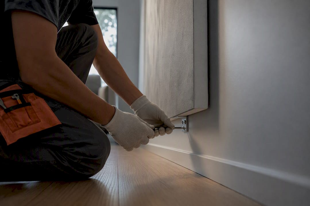 Installer securing oversized canvas wall fixings