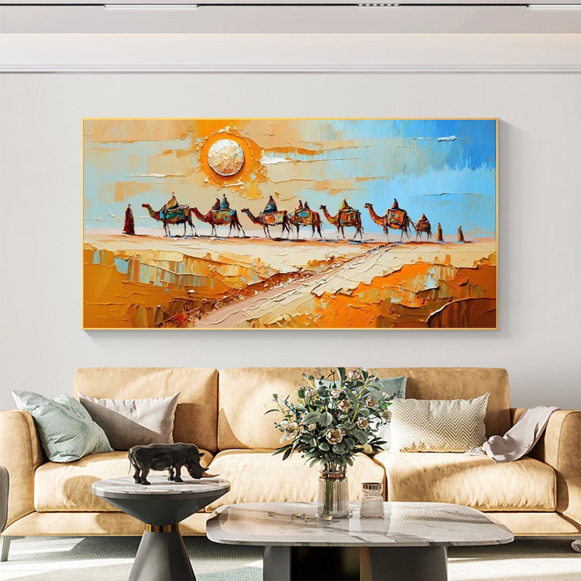 Desert caravan oil painting with vibrant orange and blue tones – A group of camels marches through the golden sand under a bright sun. Perfect for eclectic or boho-style living rooms and lounges.