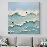 Dynamic wave painting with surfers – A textured painting of surfers riding powerful blue waves under a soft sky, capturing the thrill of the ocean. Perfect for beach-themed or coastal-inspired rooms.