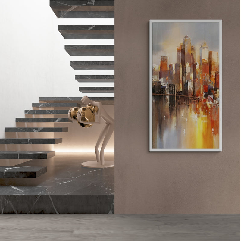 Vertical cityscape oil painting featuring glowing skyscrapers in warm sunset hues, displayed in a modern minimalist hallway next to a dramatic floating staircase.