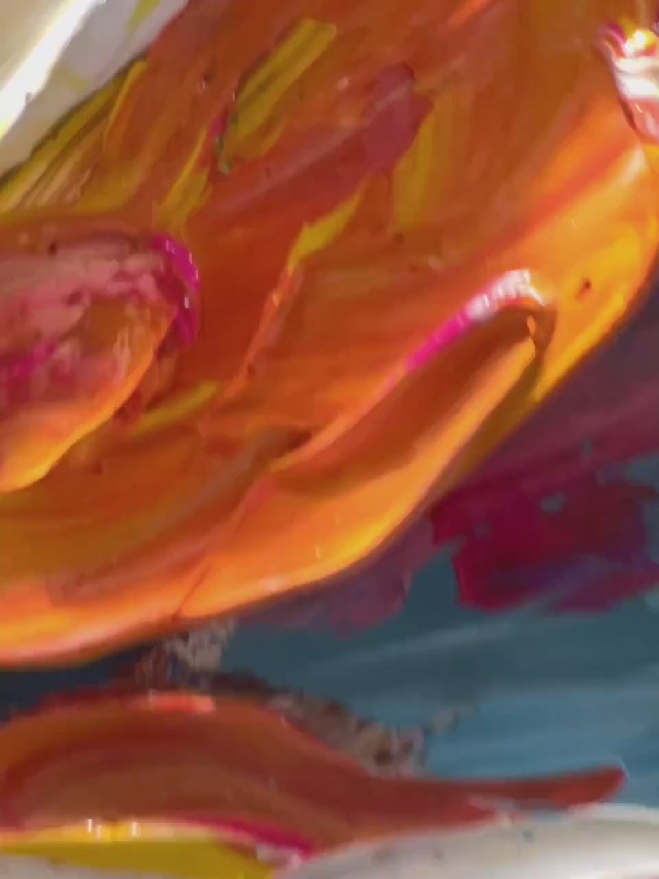 A zoom-in video showcasing the texture and vibrant brushstrokes of a bold, abstract flower painting hanging in a modern living room.